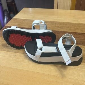 Platform white and black Teva sandals.  Only worn once.  Size 6 womens.